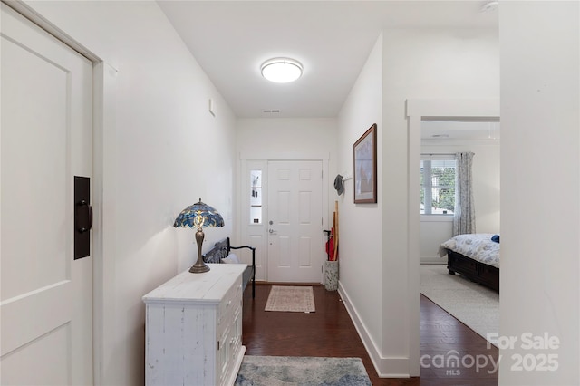 doorway with dark hardwood / wood-style flooring