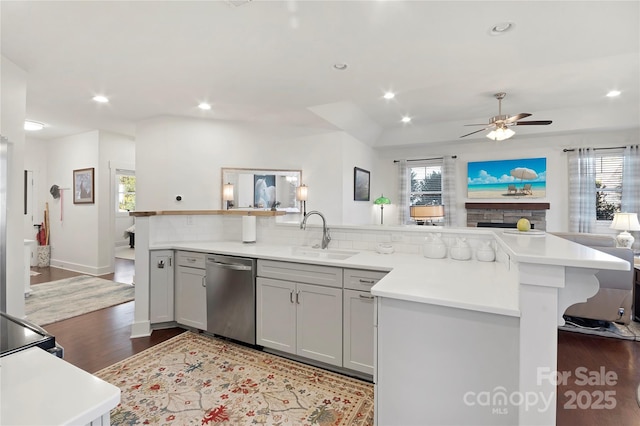 kitchen featuring gray cabinetry, sink, backsplash, and stainless steel dishwasher