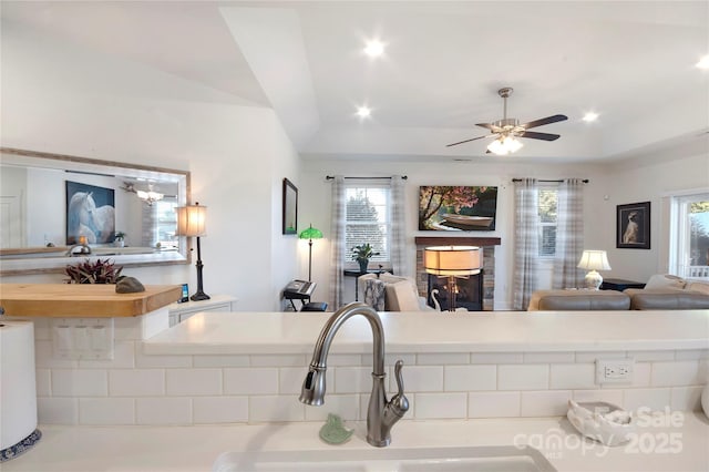 kitchen with lofted ceiling, sink, a wealth of natural light, and ceiling fan