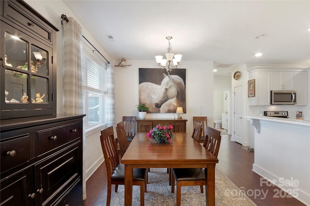 dining room featuring an inviting chandelier and dark hardwood / wood-style floors