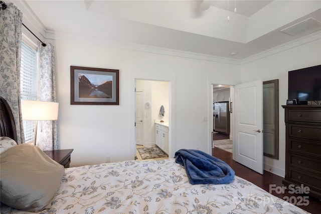 bedroom with connected bathroom, ornamental molding, stainless steel fridge, a raised ceiling, and ceiling fan