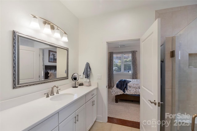 bathroom featuring walk in shower, tile patterned floors, and vanity