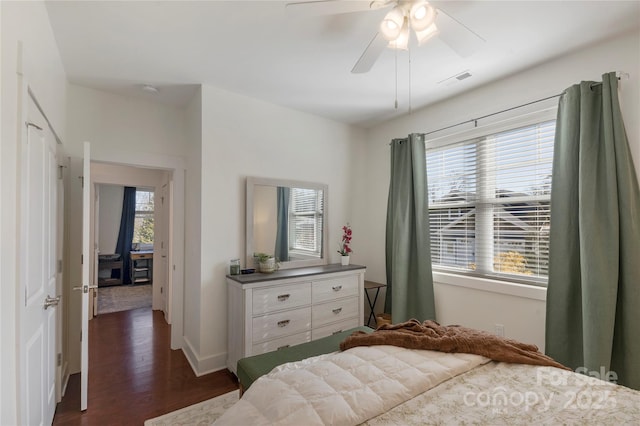 bedroom with ceiling fan and dark hardwood / wood-style floors