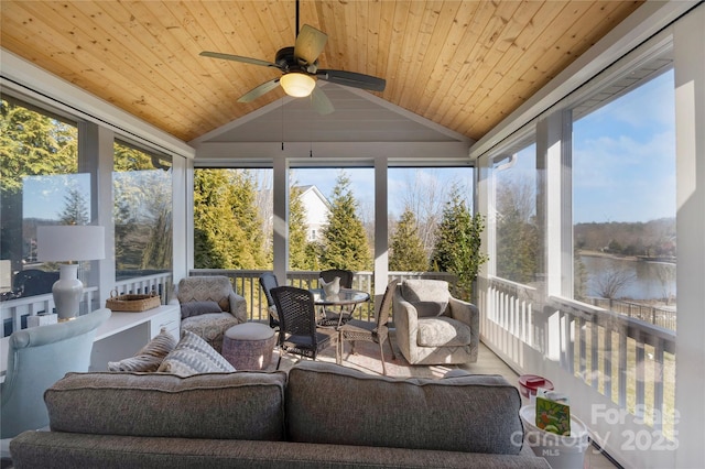 sunroom with ceiling fan, vaulted ceiling, and wooden ceiling