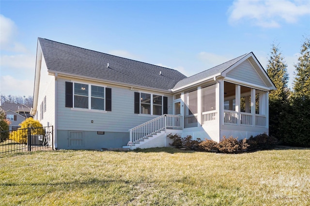 rear view of property with central AC unit, a sunroom, and a lawn