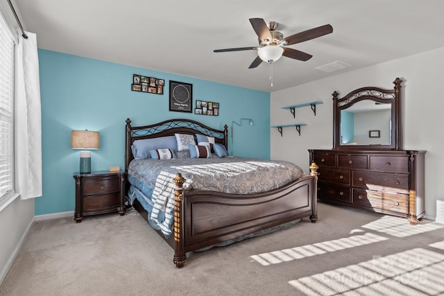 bedroom featuring light colored carpet and ceiling fan