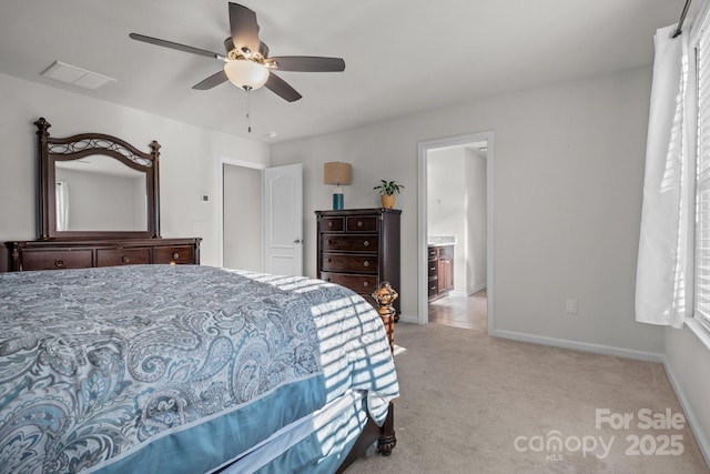 bedroom featuring connected bathroom, light colored carpet, and ceiling fan