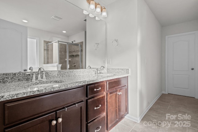 bathroom with vanity, tile patterned flooring, and walk in shower