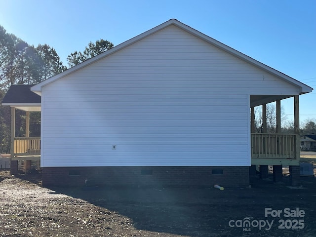 view of home's exterior with crawl space and a sunroom