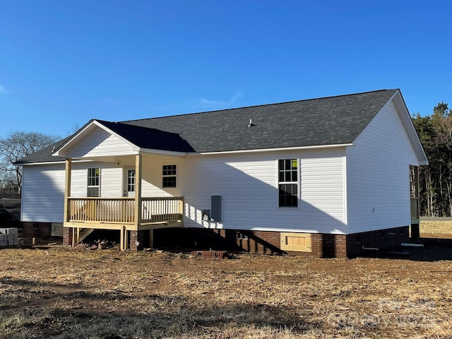 rear view of property with crawl space, a shingled roof, and a deck