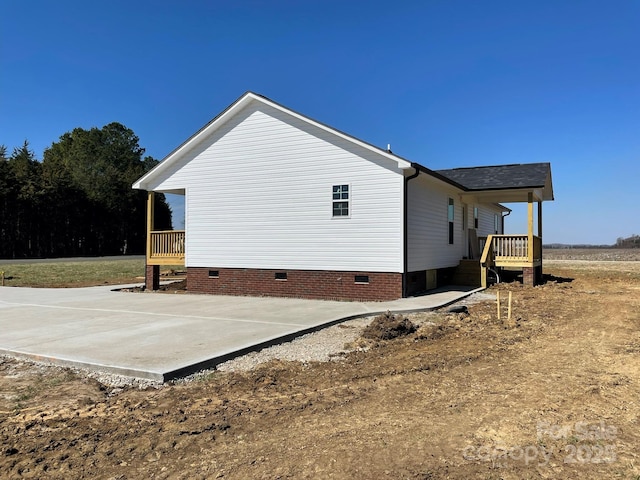 view of side of home with crawl space