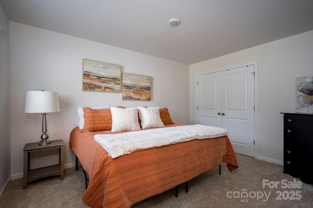 bedroom with carpet and a closet