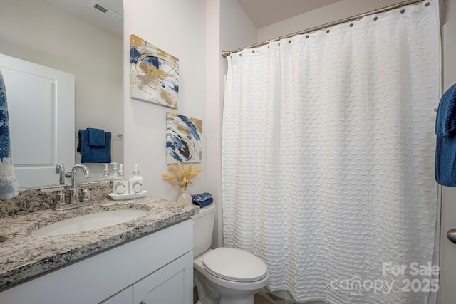 full bathroom with visible vents, toilet, and vanity