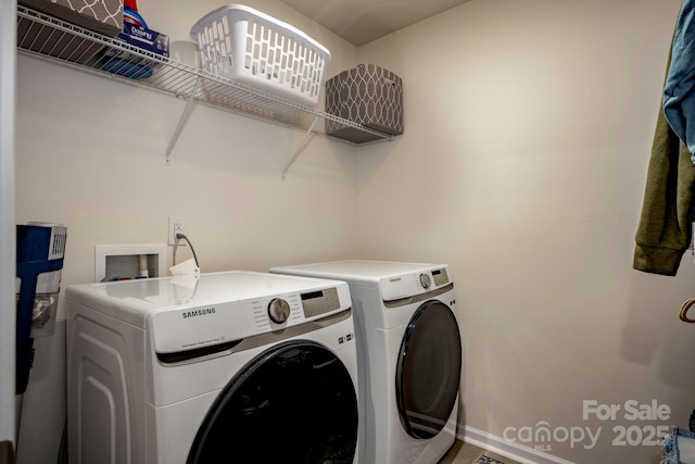 laundry room featuring washing machine and clothes dryer and laundry area