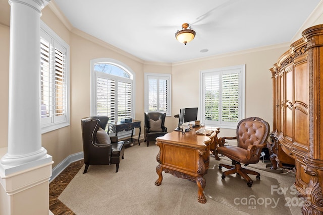 carpeted home office with decorative columns, baseboards, and ornamental molding