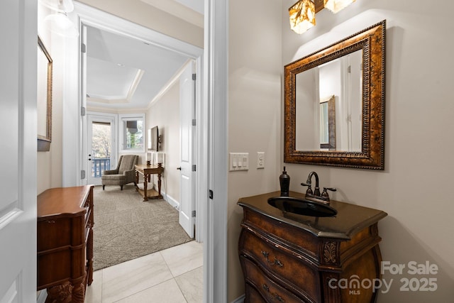 bathroom featuring vanity, crown molding, and a raised ceiling