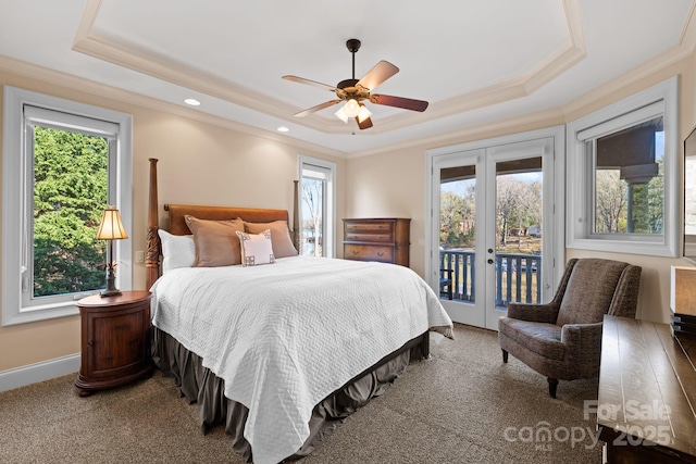 carpeted bedroom with french doors, crown molding, a tray ceiling, and access to outside