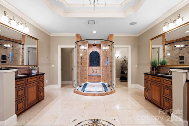 bathroom with a shower stall, a raised ceiling, and ornamental molding