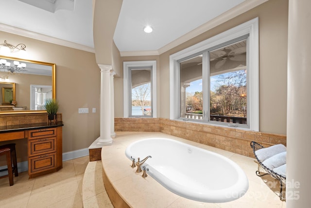 bathroom with a bath, baseboards, ornate columns, and ornamental molding