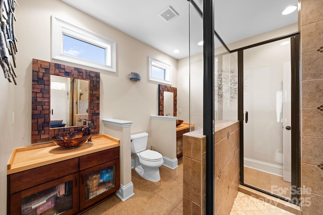 full bathroom with visible vents, toilet, a stall shower, tile patterned floors, and vanity