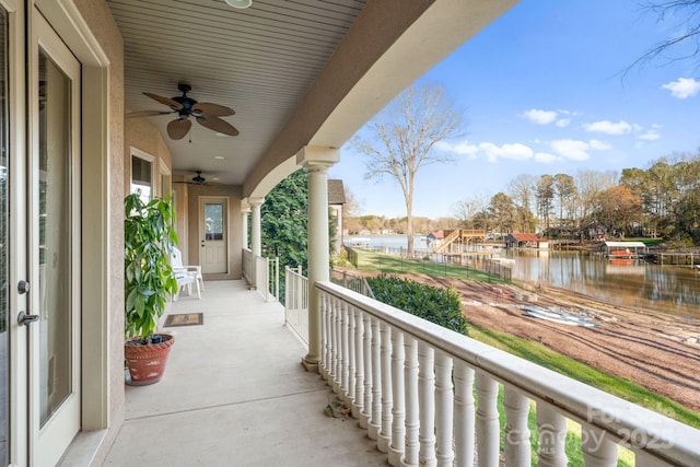 balcony with a ceiling fan and a water view