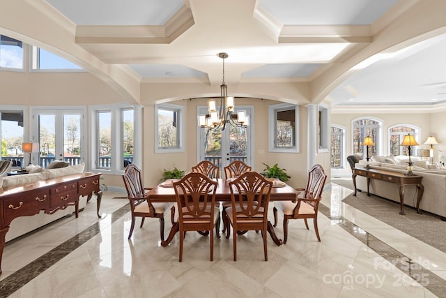 dining room with french doors, a healthy amount of sunlight, and ornate columns