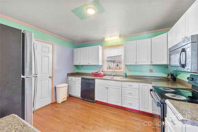 kitchen with light wood-type flooring, white cabinets, sink, and black appliances