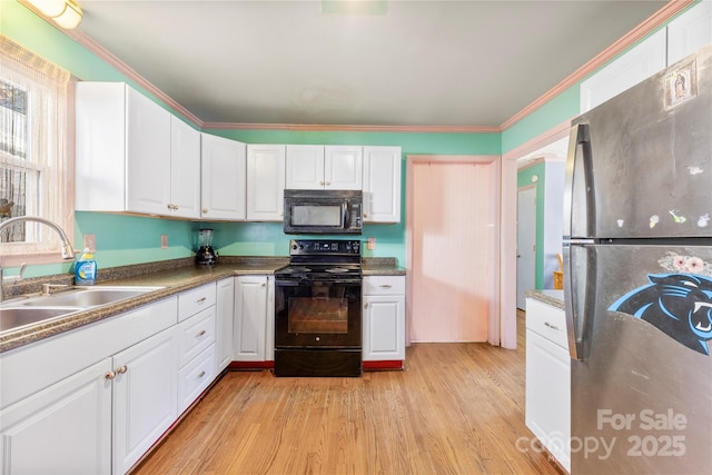 kitchen featuring sink, black appliances, light wood-type flooring, ornamental molding, and white cabinets