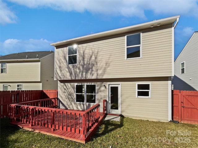 back of property featuring a yard and a deck