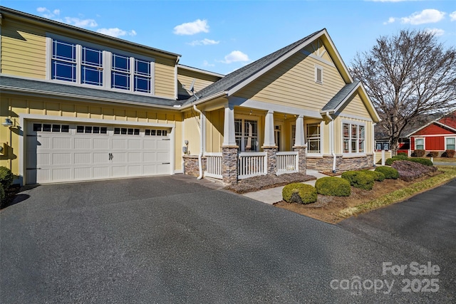 craftsman-style house featuring a garage and covered porch