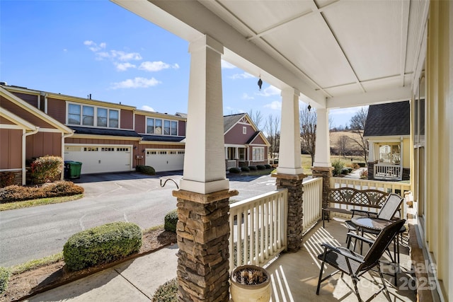 view of patio featuring a porch and a garage