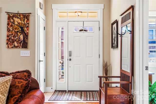 tiled entryway with a wealth of natural light