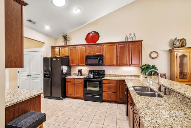 kitchen featuring sink, light tile patterned floors, high vaulted ceiling, black appliances, and light stone countertops