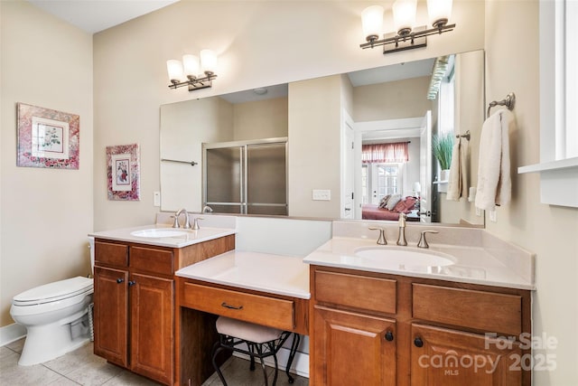 bathroom featuring vanity, toilet, an enclosed shower, and tile patterned flooring