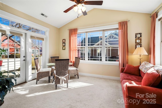 interior space with vaulted ceiling, carpet, ceiling fan, and french doors