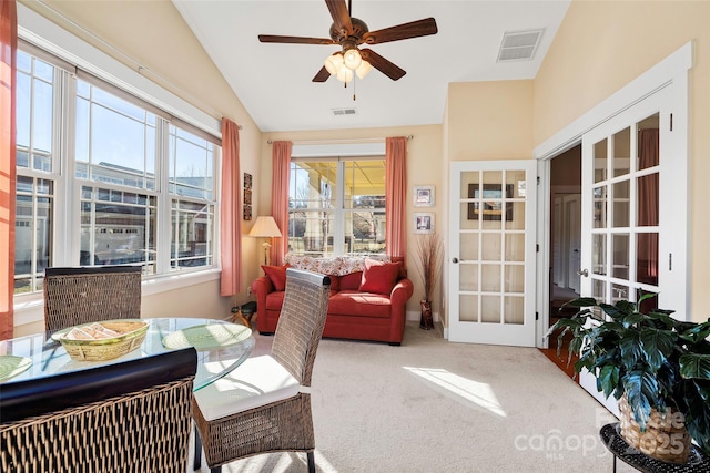 sunroom / solarium featuring vaulted ceiling, french doors, and ceiling fan