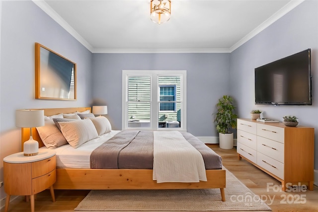 bedroom featuring ornamental molding and light wood-type flooring