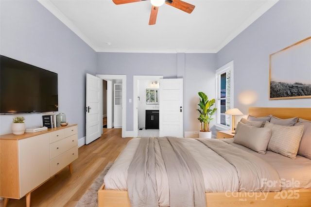 bedroom featuring ornamental molding, ceiling fan, ensuite bath, and light hardwood / wood-style flooring