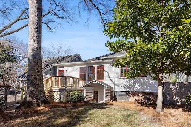 exterior space featuring a front yard and a deck