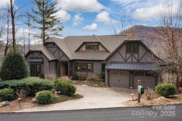 english style home featuring a garage