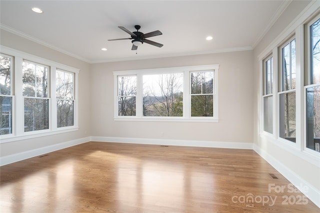 unfurnished sunroom featuring ceiling fan