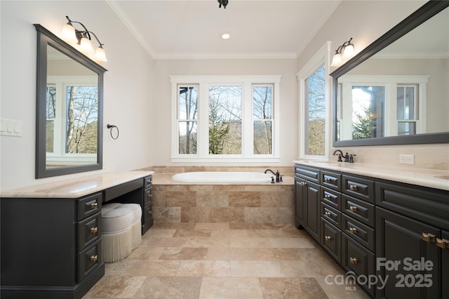 bathroom with vanity, tiled tub, and crown molding