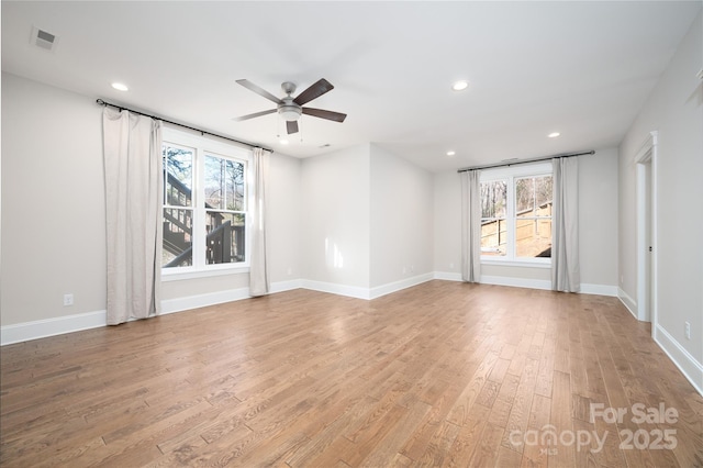 unfurnished room with ceiling fan, a wealth of natural light, and light hardwood / wood-style floors