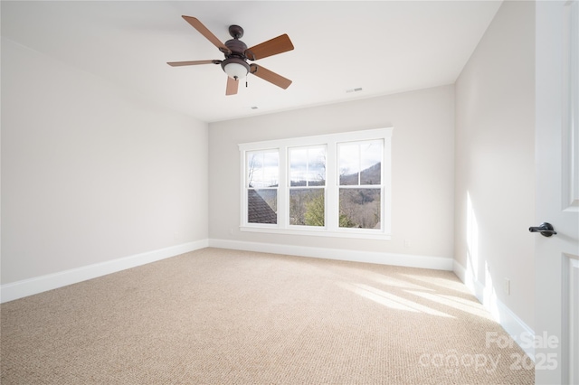 empty room featuring ceiling fan and carpet flooring