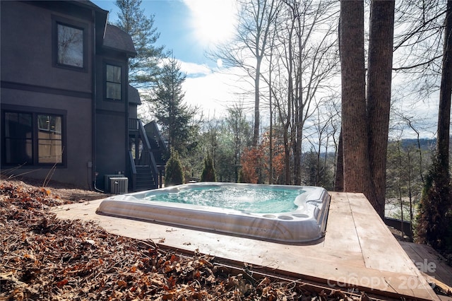 view of swimming pool with an outdoor hot tub