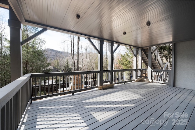 wooden terrace featuring a mountain view