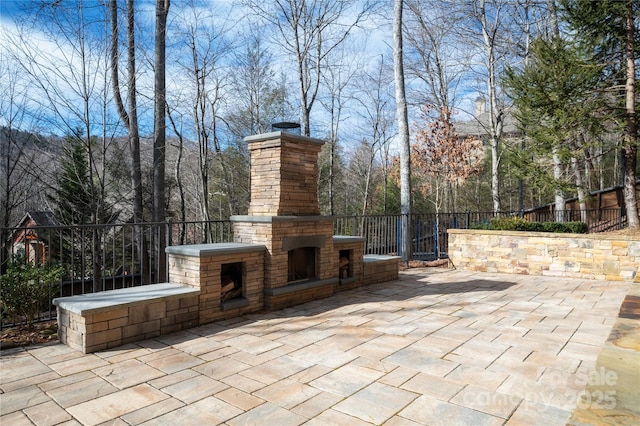 view of patio / terrace featuring an outdoor stone fireplace