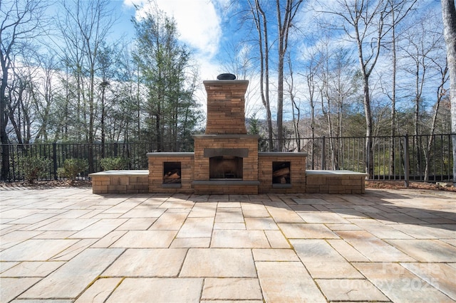 view of patio featuring an outdoor fireplace