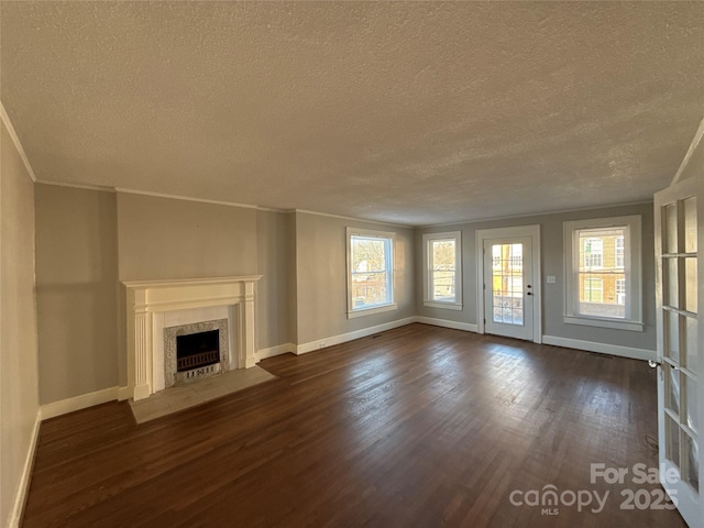 unfurnished living room with a premium fireplace, dark hardwood / wood-style floors, a textured ceiling, and crown molding