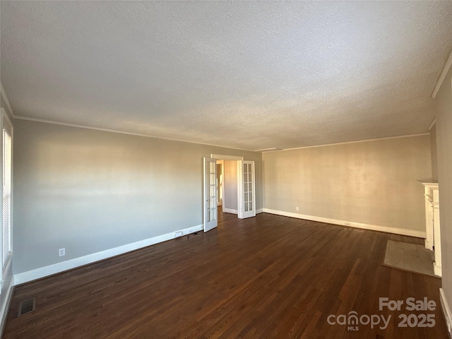 unfurnished room with crown molding, dark hardwood / wood-style floors, a textured ceiling, and french doors